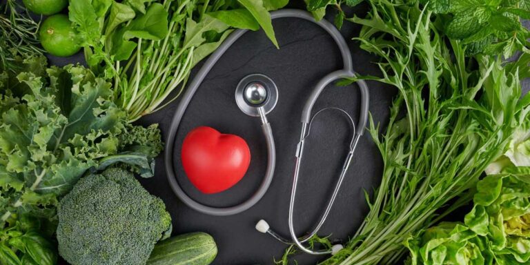 Stethoscope in the middle with healthy vegetables