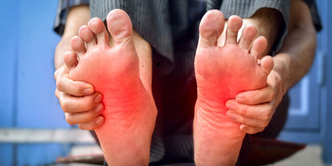 Man holding his foot with his hand