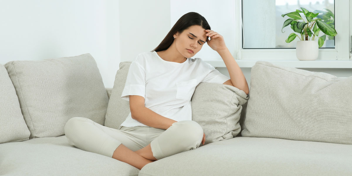 Stressed woman sitting on sofa