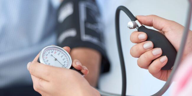 Doctor checking blood pressure of patient