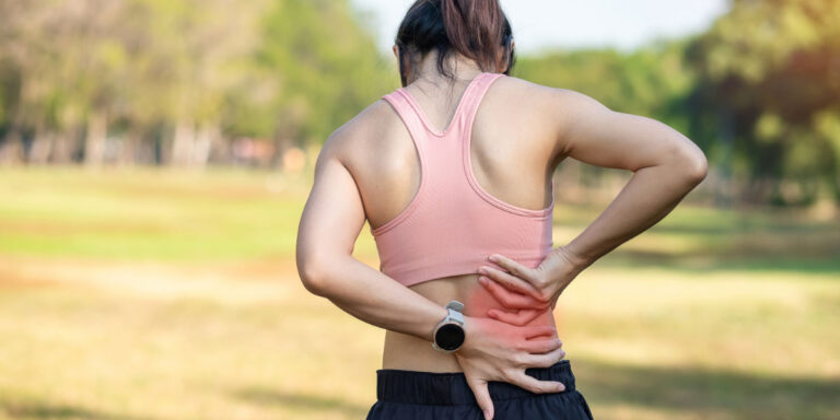 Girl having backpain while running