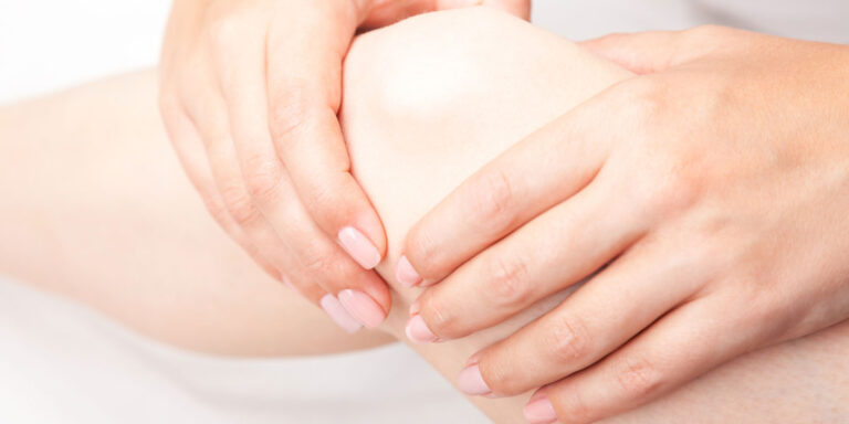 Doctor holding patient knee