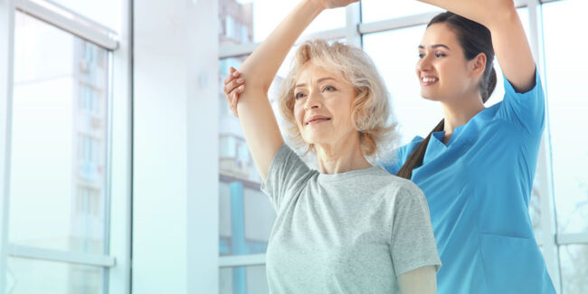 Primary Care Doctor helping an Elderly woman suffering from Osteoporosis with movement drill, post examination and consultation