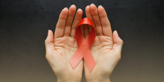 Hands holding a red ribbon