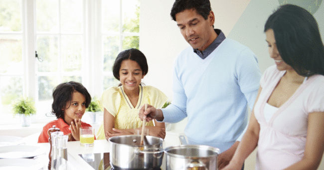 Family Cooking Meal At Home