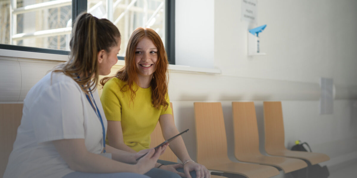 Woman speaking with primary care provider about HPV screening and cervical cancer prevention.