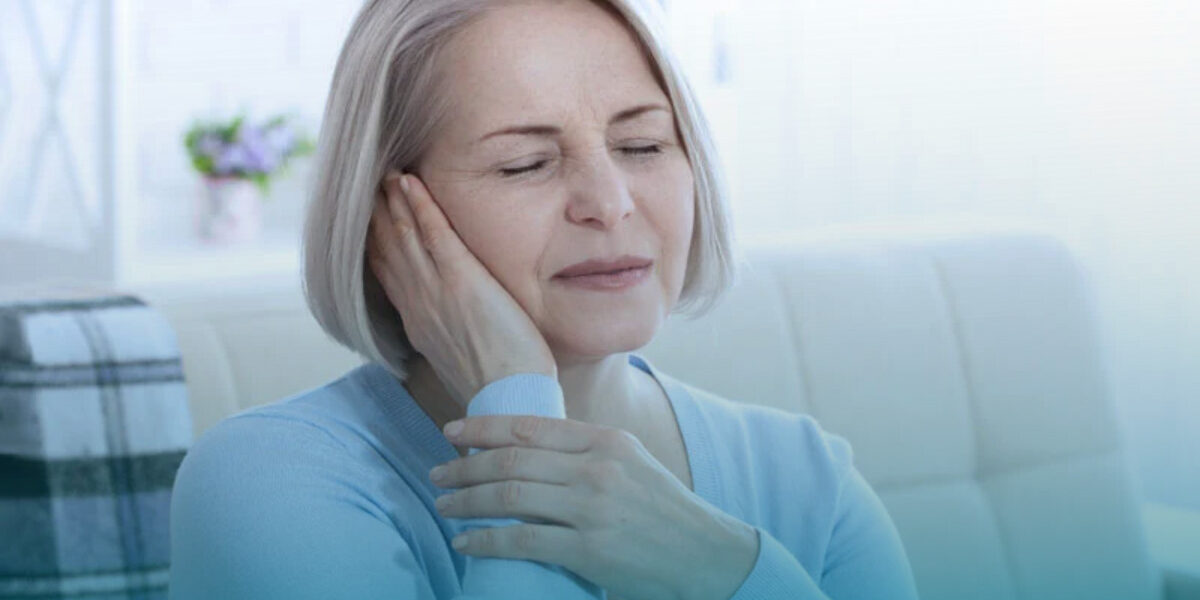 Adult experiencing ringing in the ears representing tinnitus symptoms.