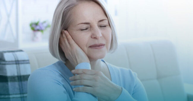 Adult experiencing ringing in the ears representing tinnitus symptoms.