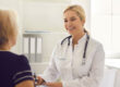 Primary care physician meeting with an adult patient during an annual physical exam focused on preventive healthcare.
