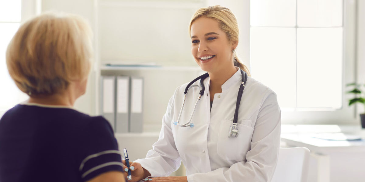Primary care physician meeting with an adult patient during an annual physical exam focused on preventive healthcare.