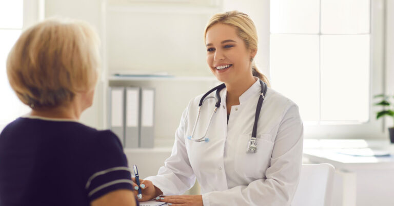 Primary care physician meeting with an adult patient during an annual physical exam focused on preventive healthcare.