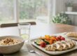 Healthy meal with grilled chicken, vegetables, oatmeal, banana, and water