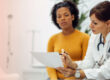 Doctor reviewing medical test results with a female patient during a healthcare consultation.